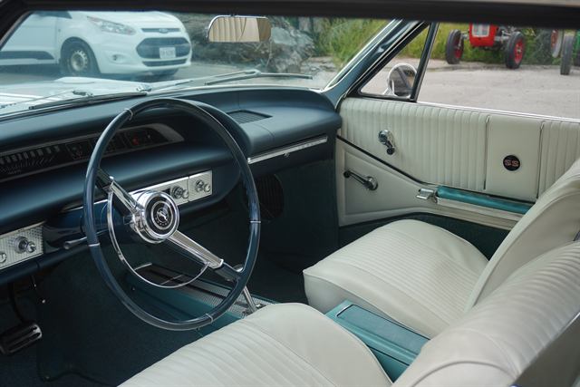 Cleaned interior of a Chevrolet Impala SS — steering wheel, dashboard, door card and front seats.