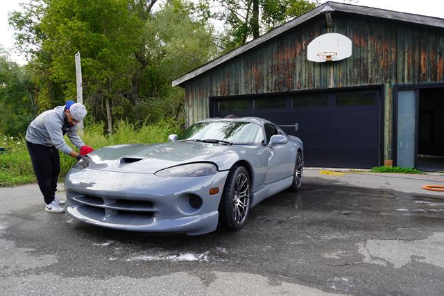 Rolling Precision hand-washing a silver Dodge Viper on a customer&rsquo;s driveway.